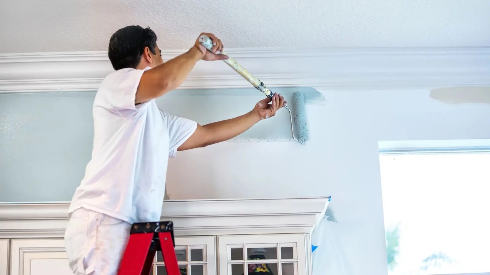 Drywall repair and painting in Los Angeles CA with wall roller